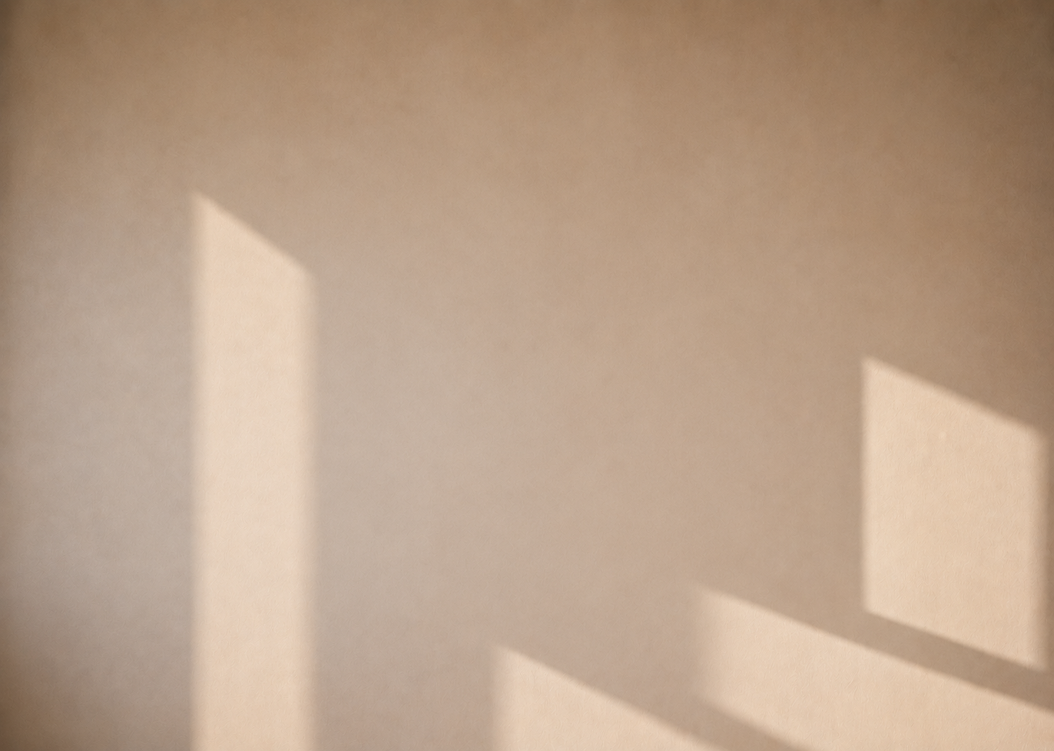 Warm plaster wall with soft window light